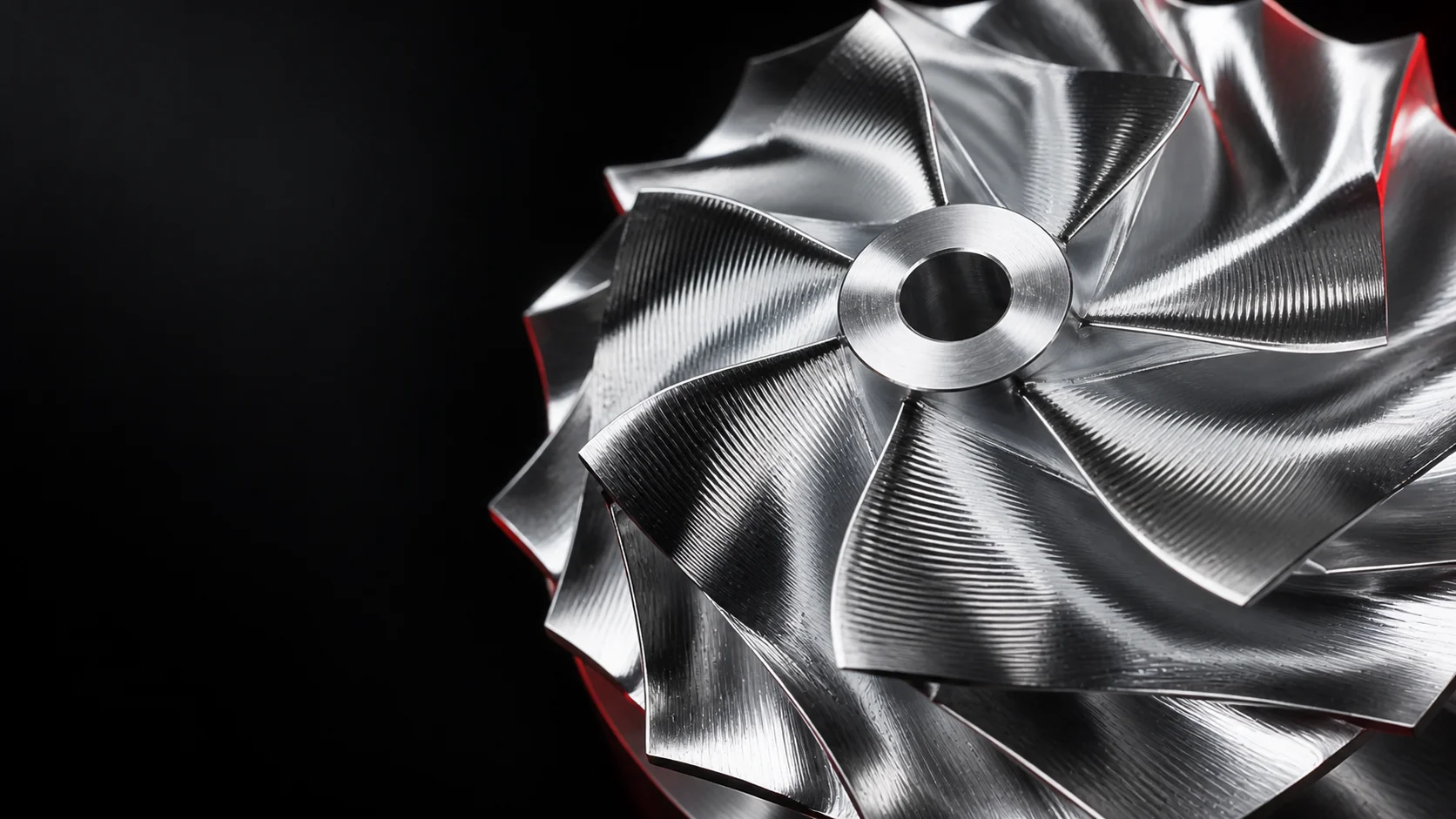 Illustration of a machined turbocharger compressor wheel with swept blades